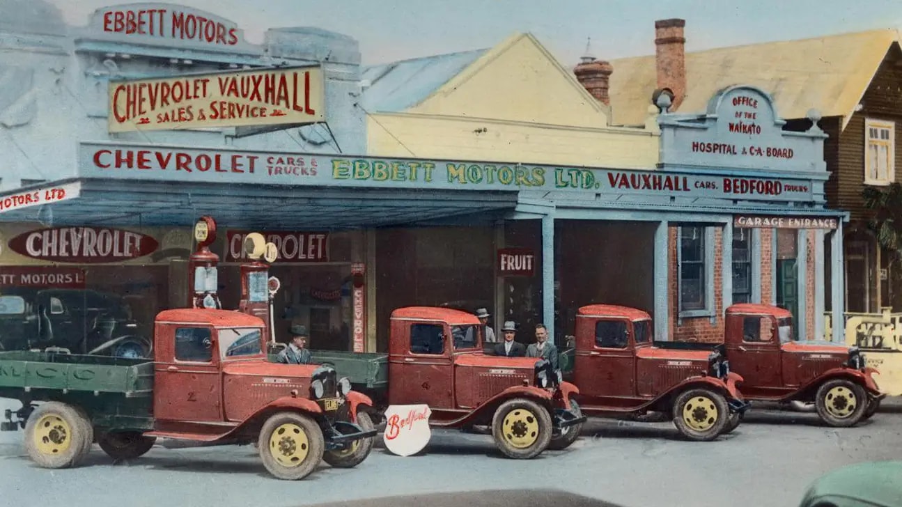 Ebbett Motors 1928 with staff and vintage trucks
